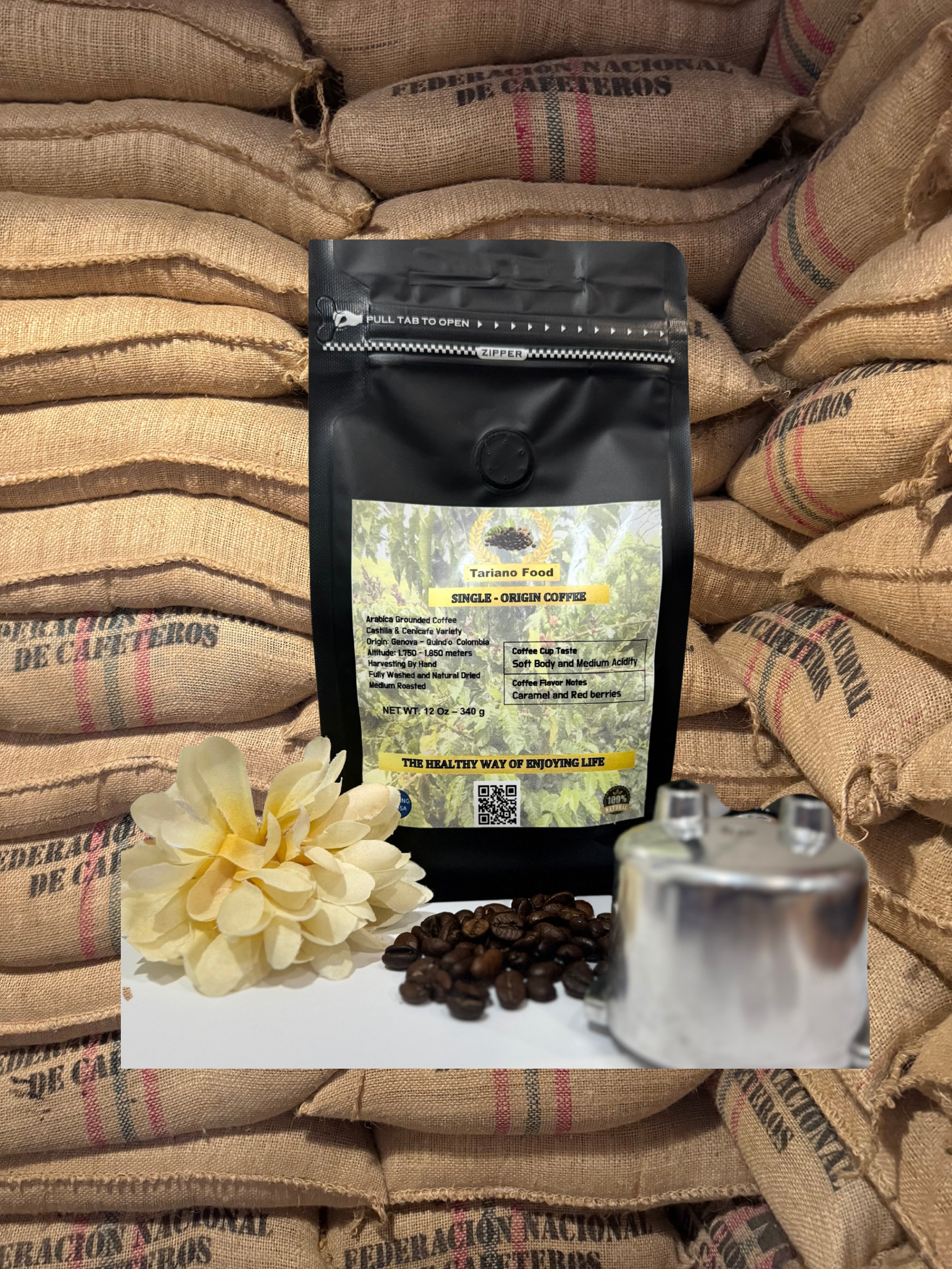 Single-origin coffee bag presented in front of burlap sacks, with coffee beans and a flower accentuating its branding and quality.