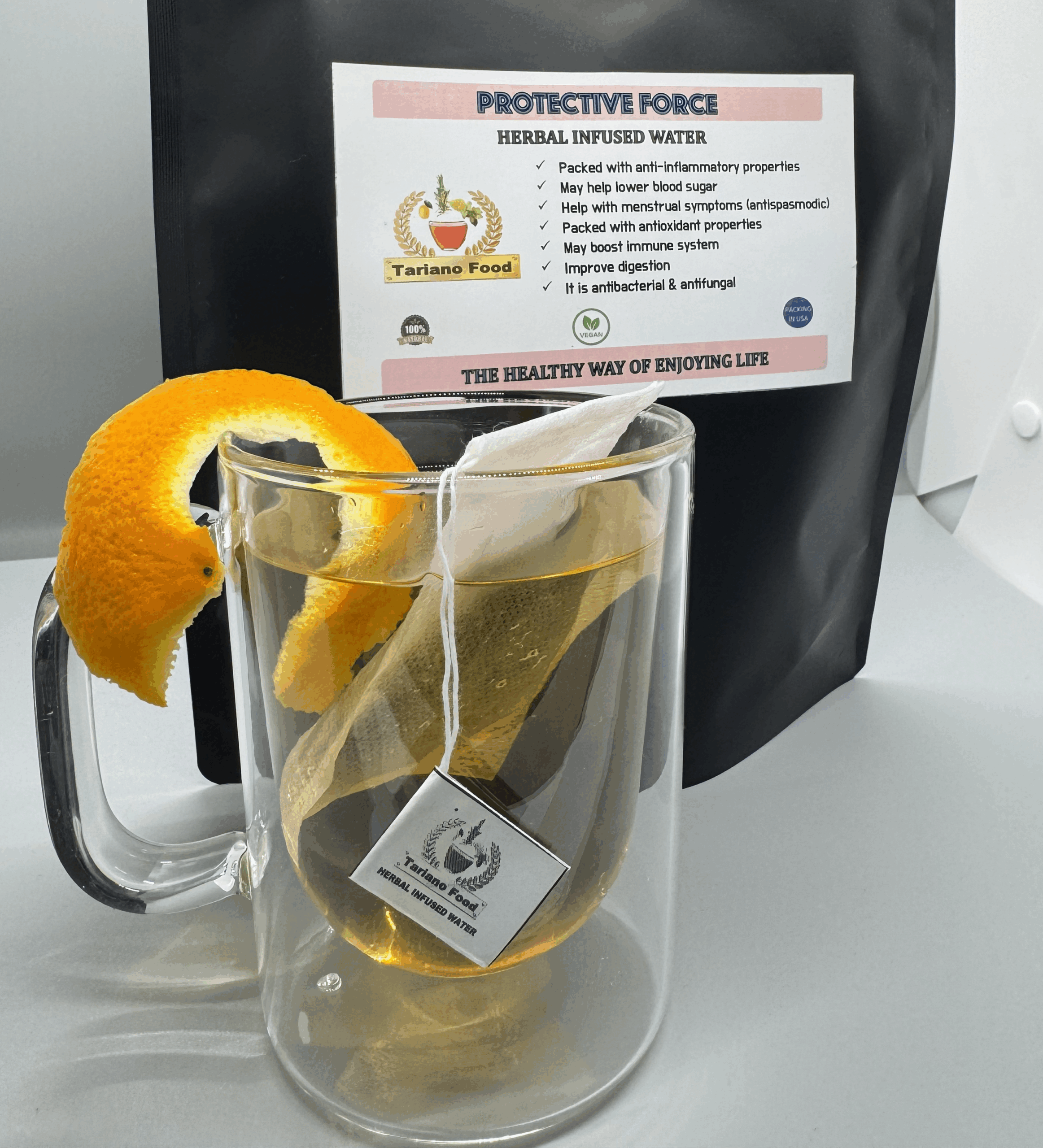 Herbal infused water labeled "Protective Force," featuring a tea bag in a clear mug with orange peel garnish. Offers health benefits like immune support.